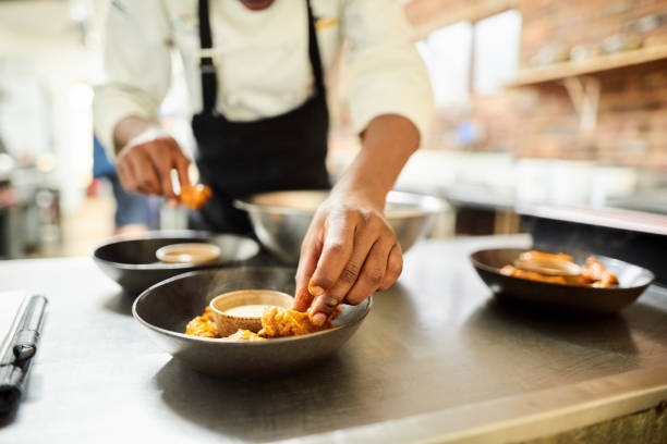 Chef crafting a gourmet dish in a fancy restaurant kitchen, showcasing upscale dining creativity